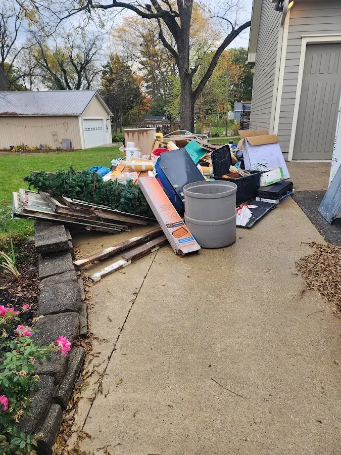 Dumpster being loaded with debris for Residential Dumpster Rental in Eglin AFB